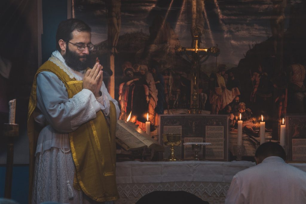 A member of a Catholic church reciting Last Rites