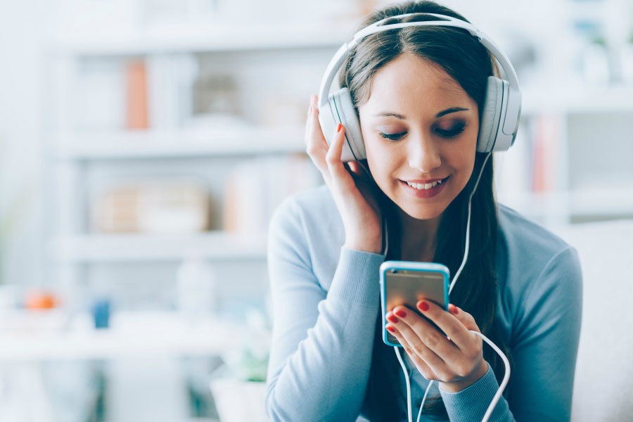 A lady listening to songs about new beginnings